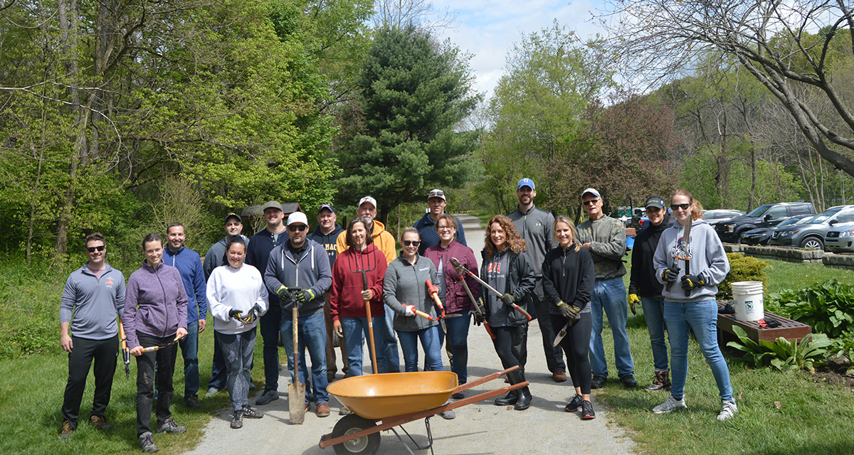There are a group of Equitrans volunteers at Montour Trail with gardening supplies for planting and park maintenance.